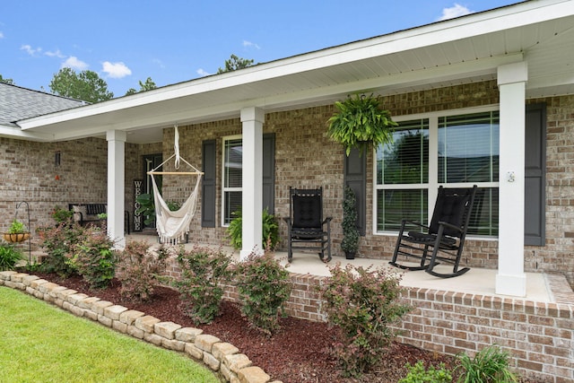 rear view of property featuring covered porch