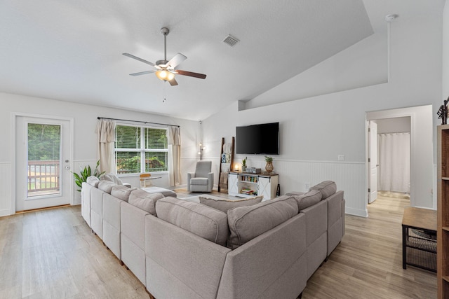 living room featuring ceiling fan, light hardwood / wood-style flooring, and high vaulted ceiling