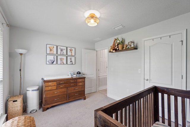 bedroom with light carpet and a crib