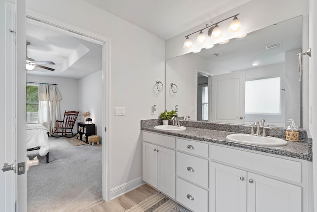 bathroom with vanity, ceiling fan, and wood-type flooring