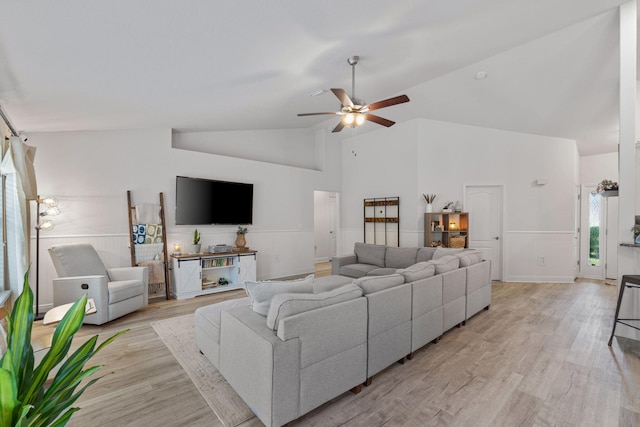 living room with ceiling fan, high vaulted ceiling, and light hardwood / wood-style floors