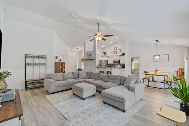 living room featuring high vaulted ceiling, ceiling fan, and light hardwood / wood-style floors