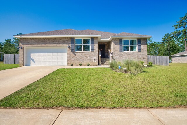 6537 Torrey Pnes, Laurel Hill, FL 32567 - view of front facade with a front yard, concrete driveway, a garage, and fence