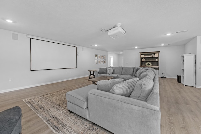 cinema room featuring light wood-type flooring