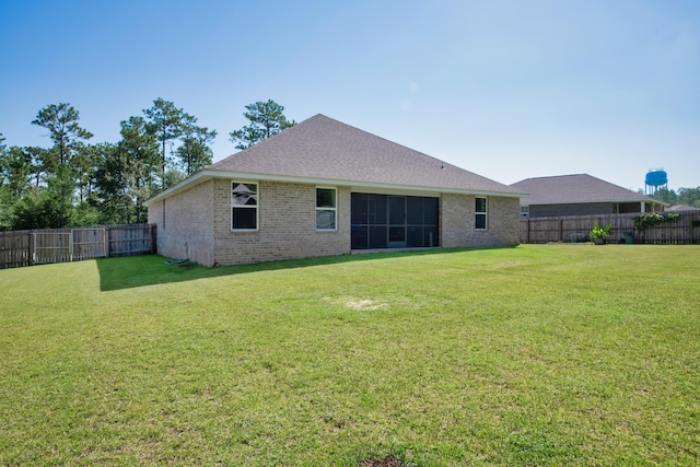 back of property featuring a yard