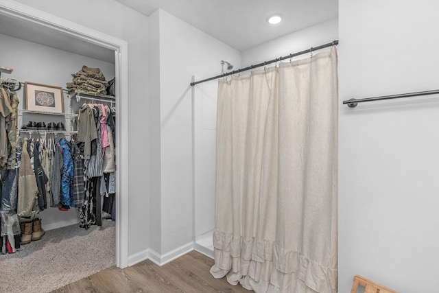 6537 Torrey Pnes, Laurel Hill, FL 32567 - full bath featuring a shower with curtain, baseboards, wood finished floors, and a walk in closet