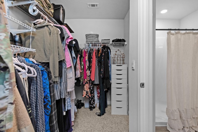 spacious closet featuring carpet flooring