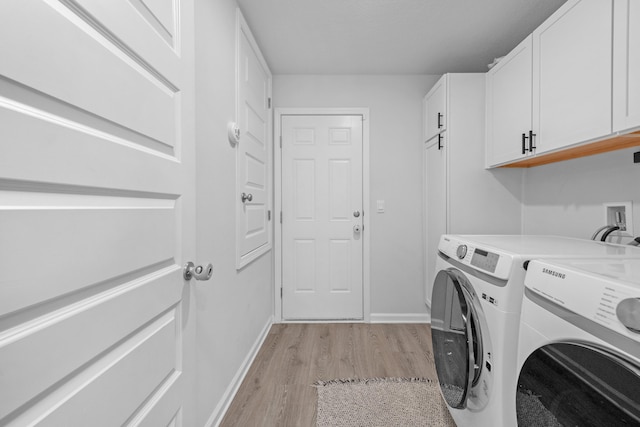 laundry area with light hardwood / wood-style floors, separate washer and dryer, and cabinets