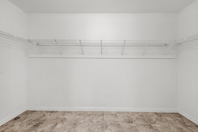 spacious closet featuring light tile patterned floors