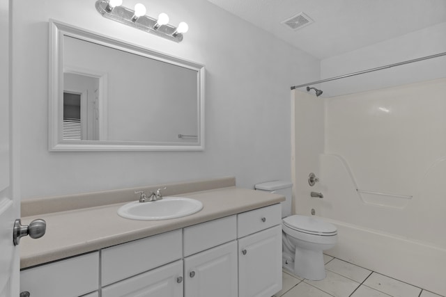 full bathroom with shower / tub combination, vanity, tile patterned floors, and toilet