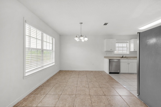 interior space featuring a notable chandelier, sink, light tile patterned flooring, and plenty of natural light