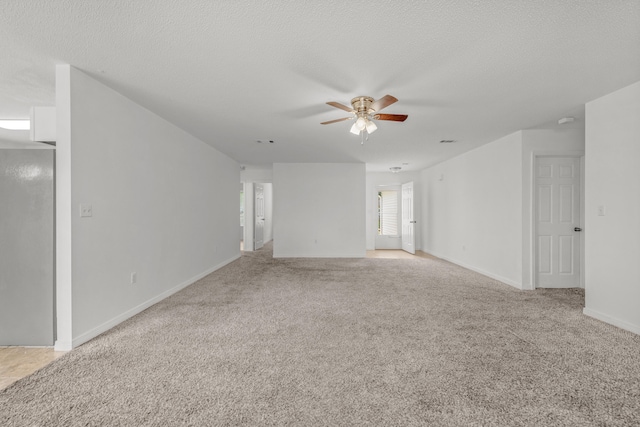 unfurnished room with light carpet, ceiling fan, and a textured ceiling