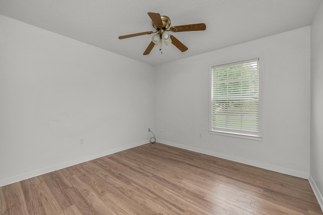 spare room featuring light hardwood / wood-style floors and ceiling fan