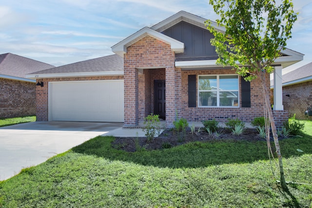 view of front of home featuring a garage and a front yard