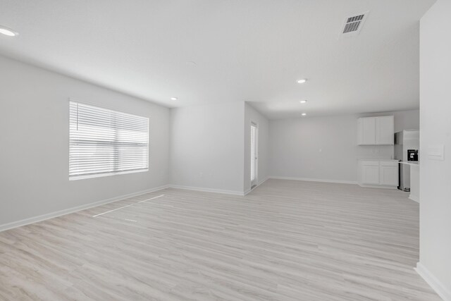 unfurnished living room with light hardwood / wood-style flooring