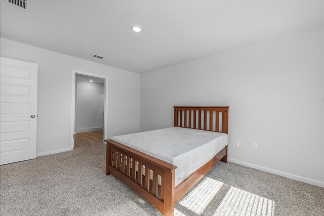 carpeted bedroom with a closet