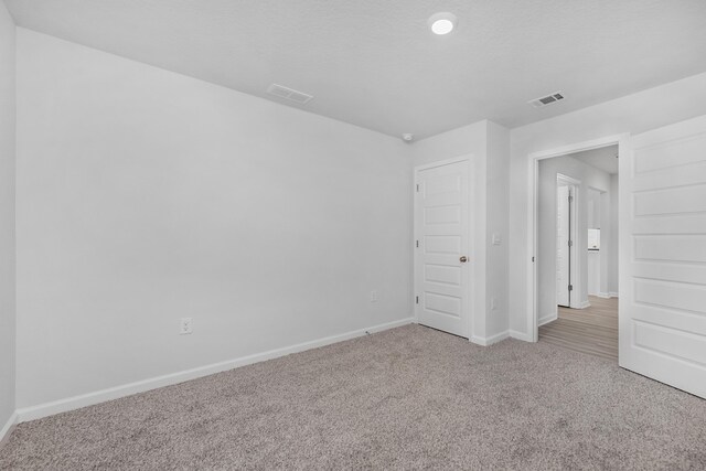 empty room with light colored carpet