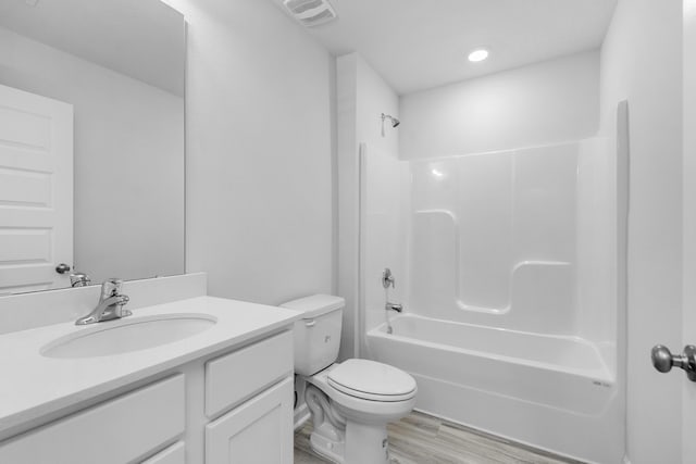 full bathroom featuring vanity, shower / bath combination, toilet, and wood-type flooring