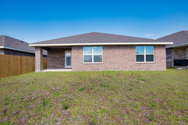 rear view of house with a lawn