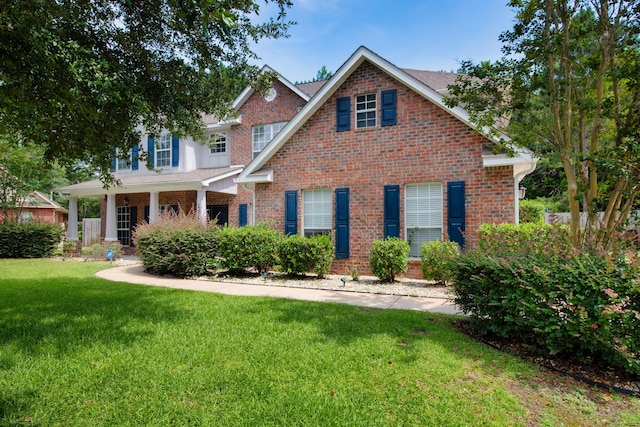 view of front facade featuring a front yard and brick siding