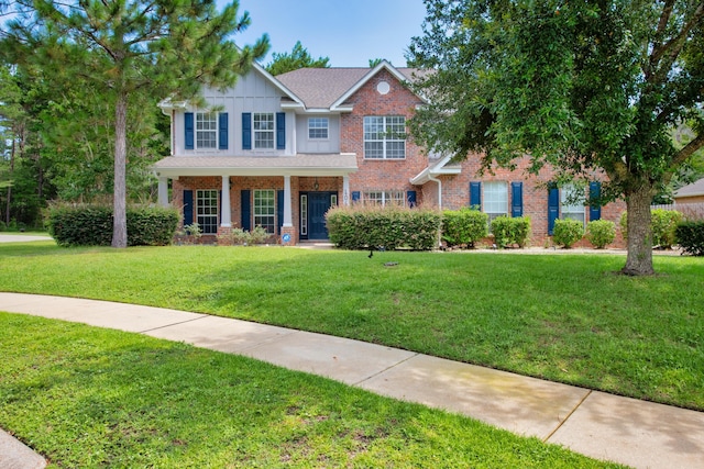 view of front of property with a front yard and brick siding