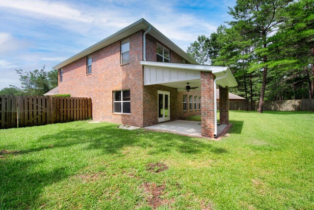 rear view of property with a patio, ceiling fan, and a lawn