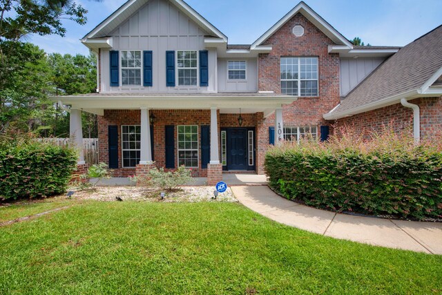 view of front of home with a porch and a front lawn