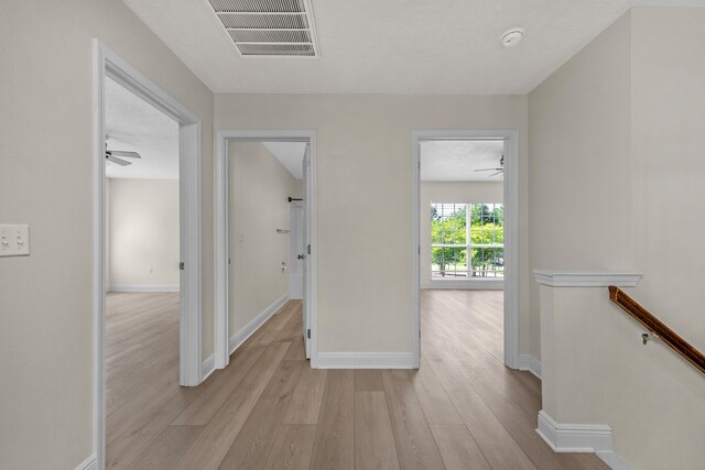 hallway with light hardwood / wood-style flooring