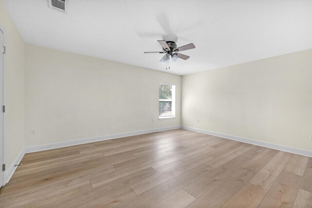 empty room with light wood-type flooring and ceiling fan