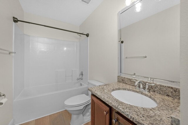 full bathroom with vanity, wood-type flooring, toilet, and  shower combination