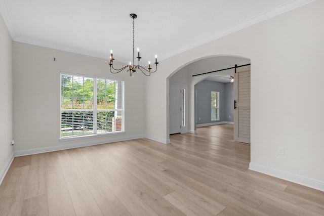 empty room featuring arched walkways, crown molding, light wood-style floors, baseboards, and ceiling fan with notable chandelier