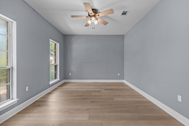 empty room with light hardwood / wood-style floors and ceiling fan