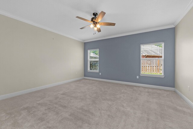 unfurnished room with ornamental molding, light carpet, and ceiling fan