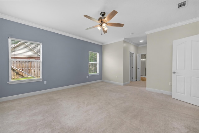 unfurnished room with crown molding, visible vents, a ceiling fan, light carpet, and baseboards