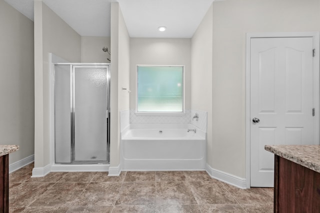 bathroom featuring tile patterned flooring, plus walk in shower, and vanity