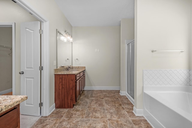 bathroom with plus walk in shower, vanity, and tile patterned floors