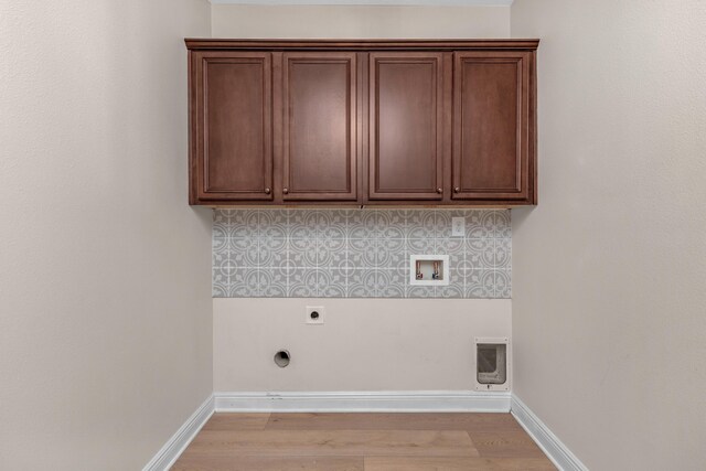 washroom featuring light hardwood / wood-style floors, cabinets, electric dryer hookup, and washer hookup