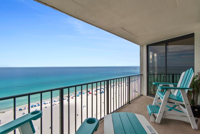 balcony with a beach view and a water view