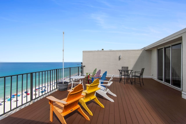 deck with a water view and a beach view