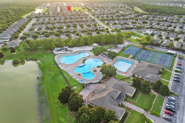 birds eye view of property with a water view