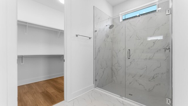 bathroom featuring hardwood / wood-style flooring and a shower with door