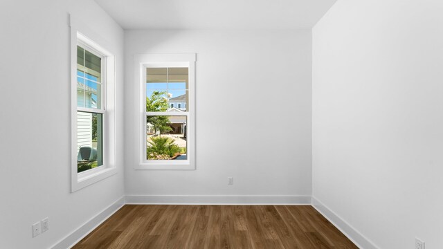 unfurnished room with wood-type flooring