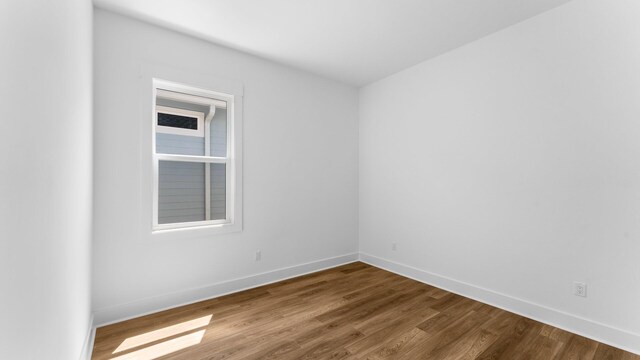 spare room featuring hardwood / wood-style floors