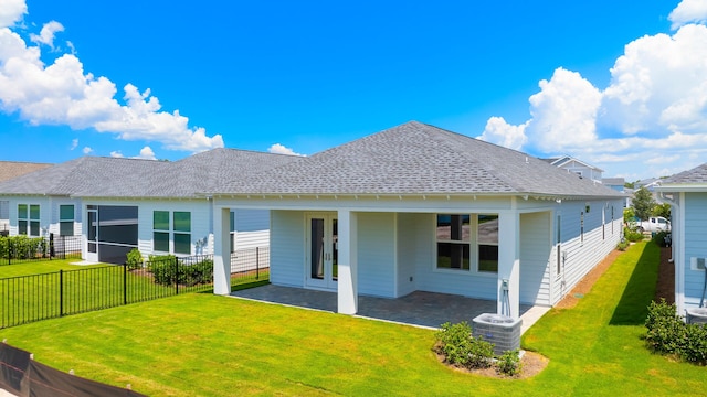 back of house featuring a patio and a lawn