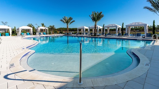 view of pool with a patio area and a gazebo