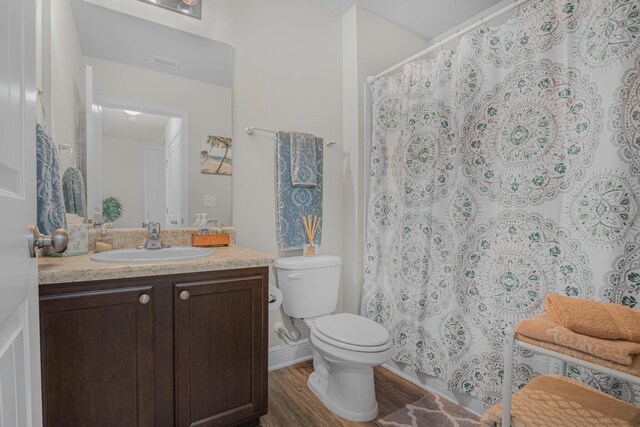 5736 Callaway Cir, Panama City, FL 32404 - bathroom featuring vanity, toilet, and hardwood / wood-style floors