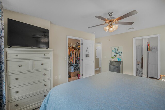 5736 Callaway Cir, Panama City, FL 32404 - bedroom with a walk in closet, ensuite bath, ceiling fan, and a closet