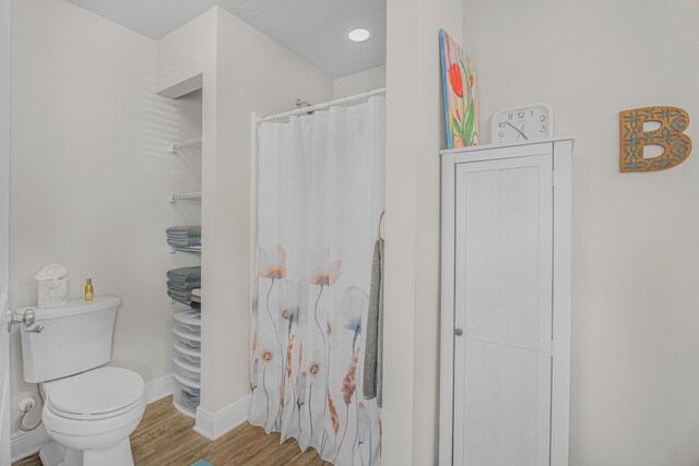 5736 Callaway Cir, Panama City, FL 32404 - bathroom featuring a shower with curtain, toilet, and hardwood / wood-style floors