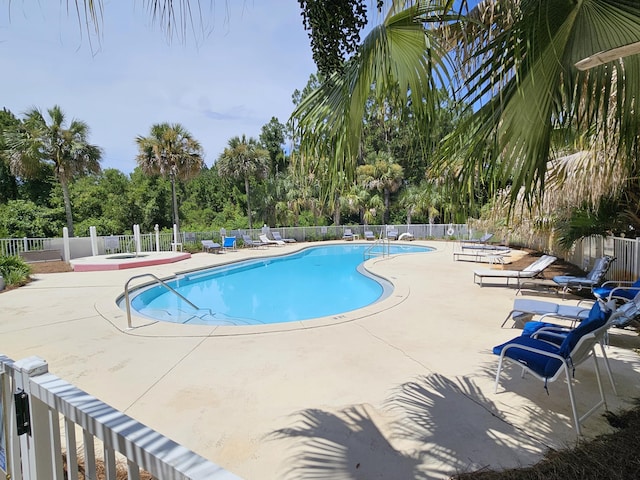 view of swimming pool featuring a patio area and a community hot tub