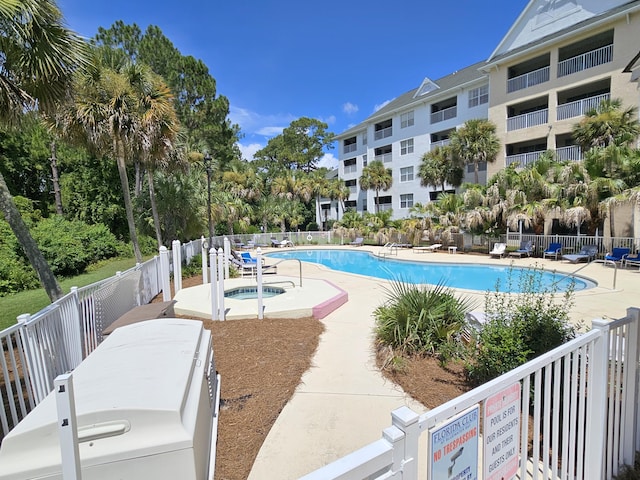 view of pool with a community hot tub and a patio